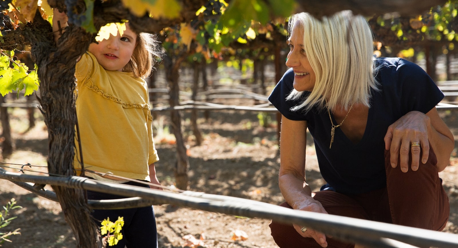 lady and child in a vineyard