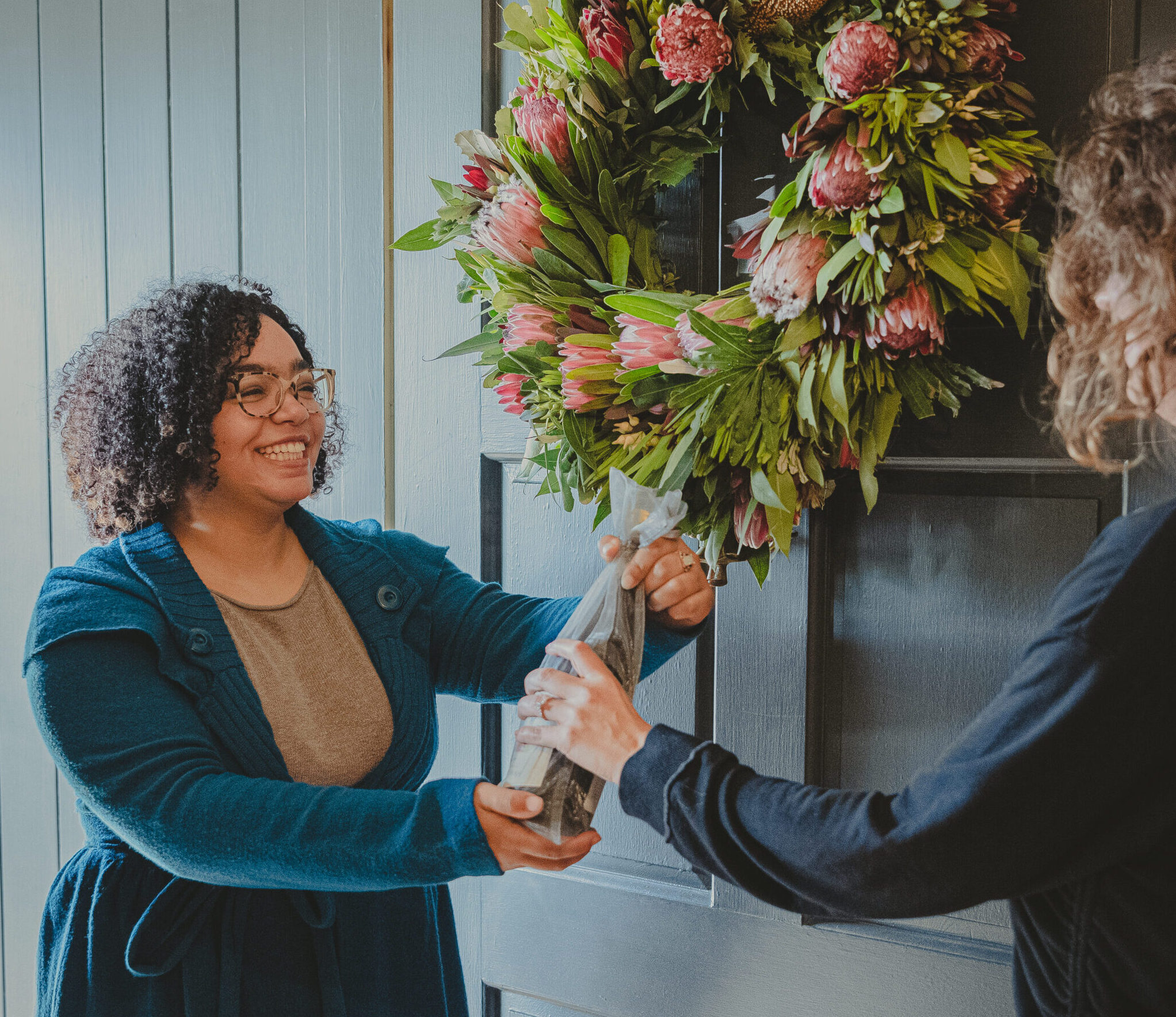 woman giving wine as a gift