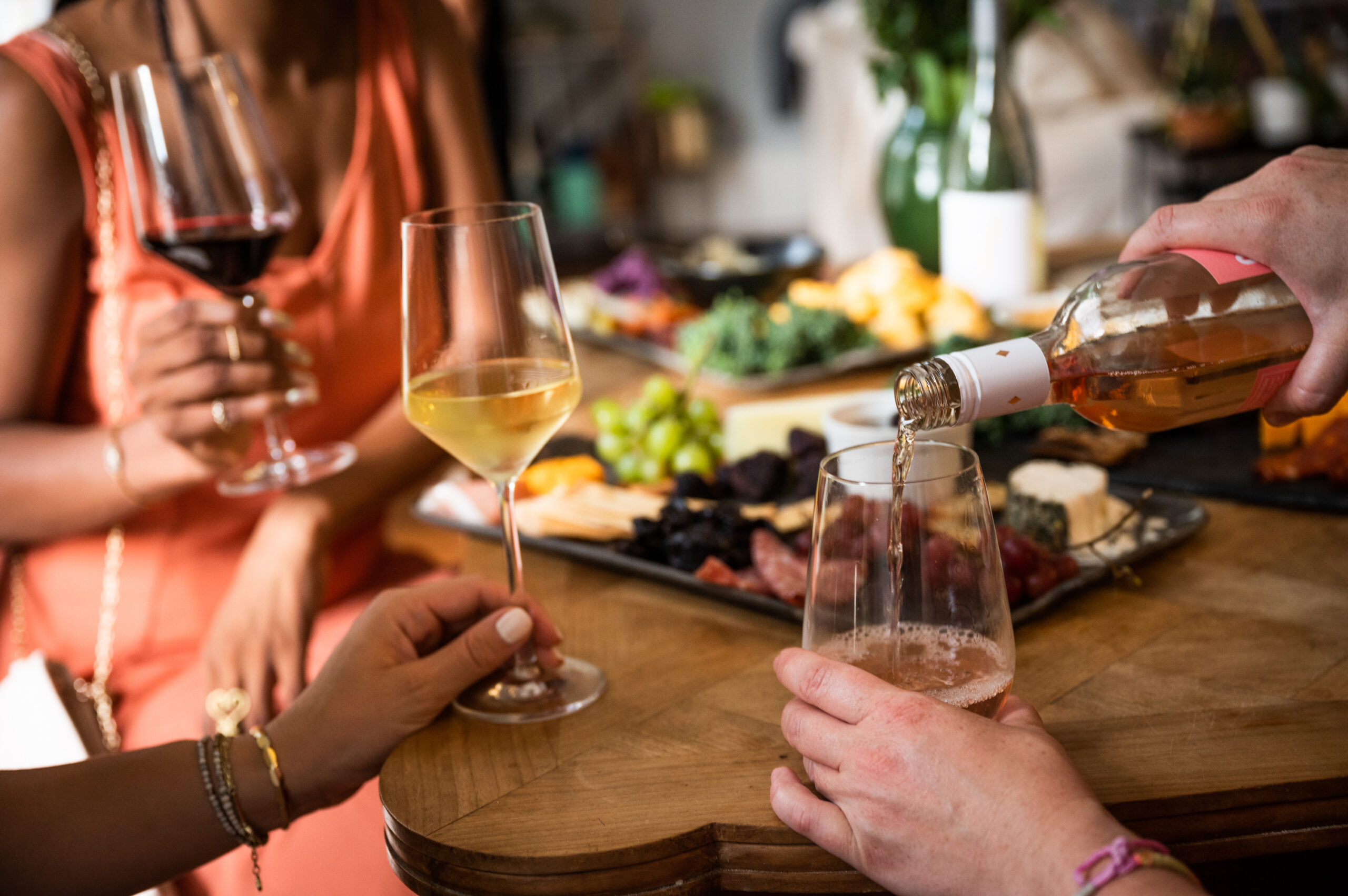 women drinking wine with food