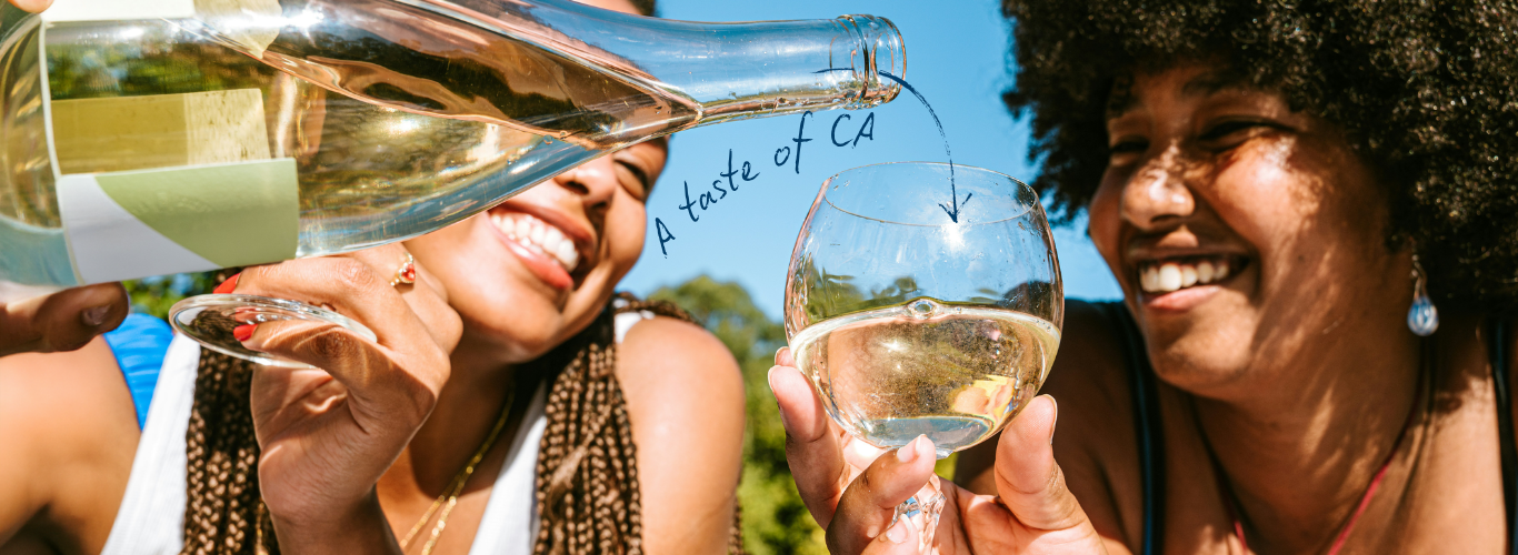 two women pouring wine and smiling