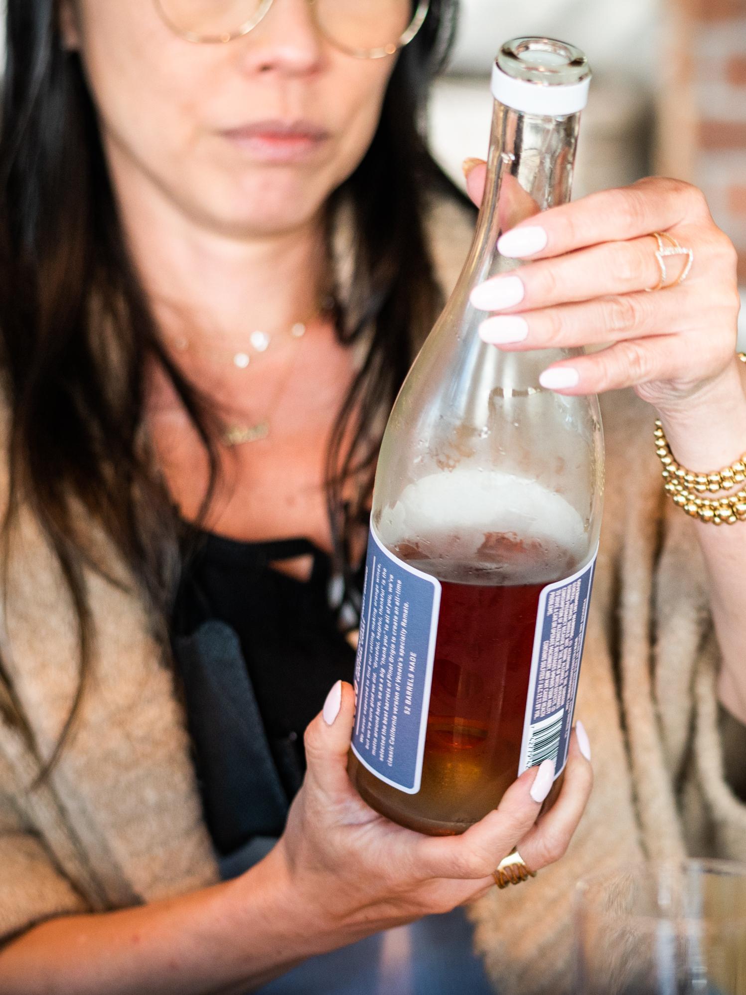 woman reading wine label