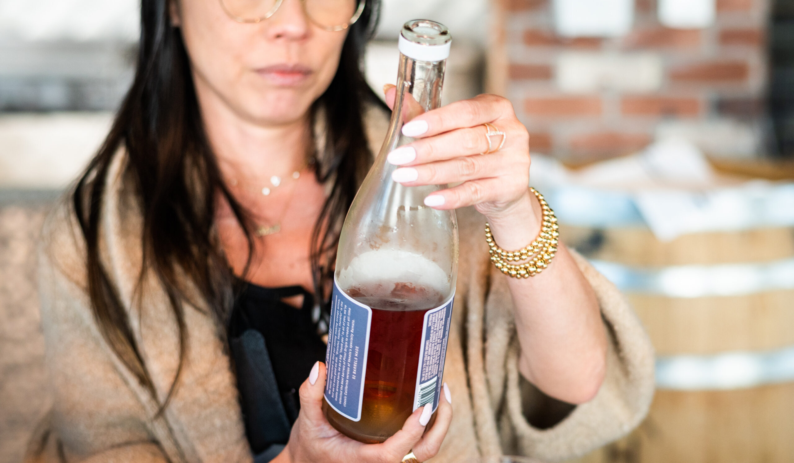 woman looking at wine bottle label